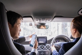 車の中で電話している会社員の画像.jpg